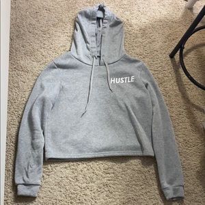 “Hustle” labeled cropped sweater.